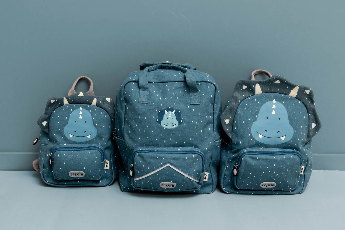 Trixie backpacks Mr. Triceratops 