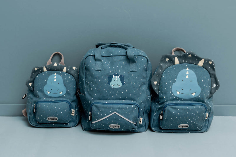 Trixie backpacks Mr. Triceratops 